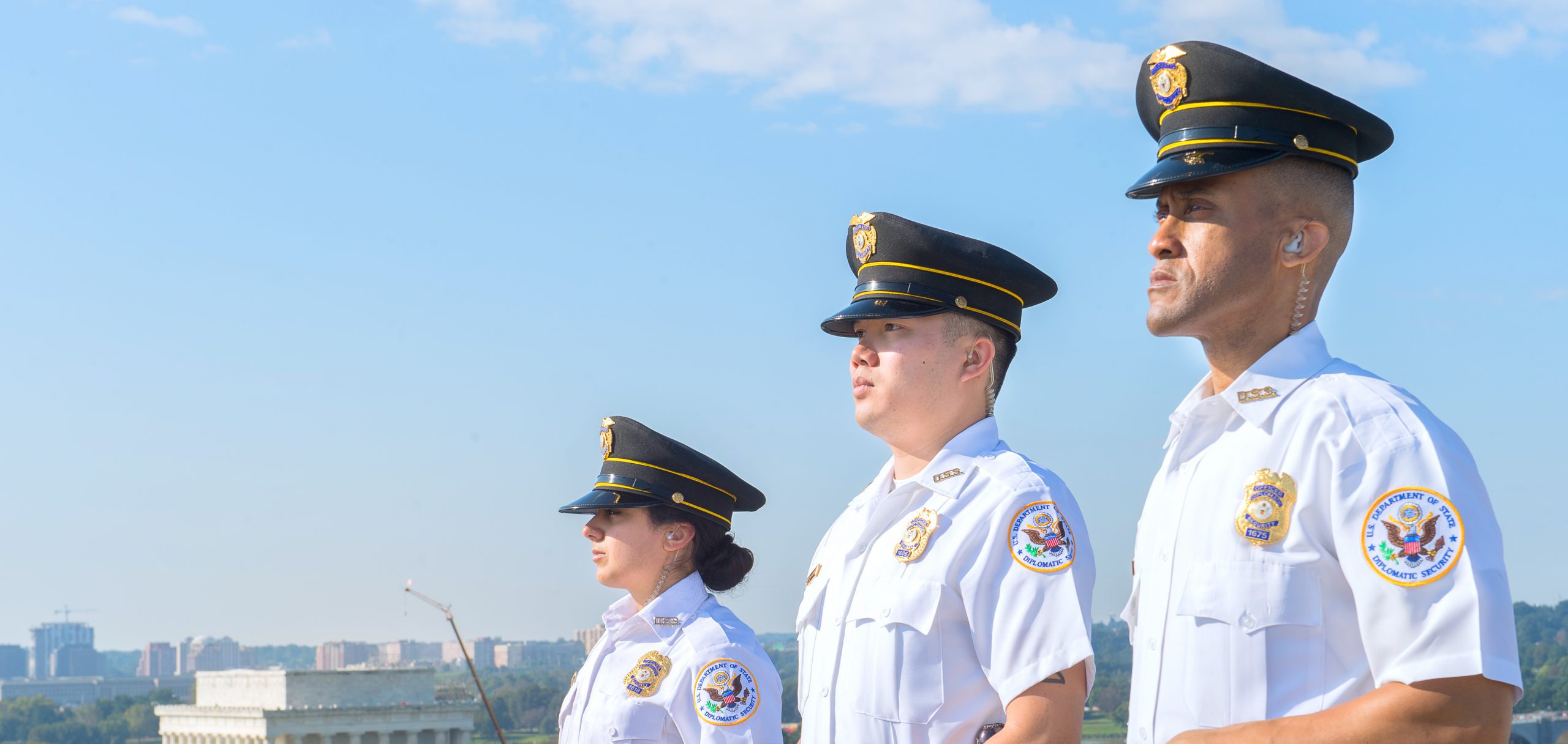 Inter-Con Security guards stand on watch on top of building